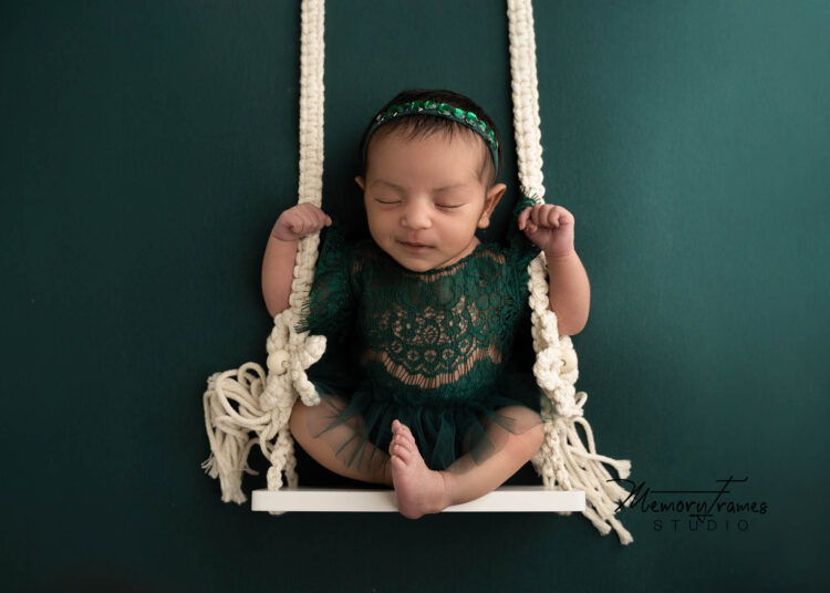 newborn baby on swing posed for newborn photoshoot at kitchener, how to take newborn photos at home in swing.