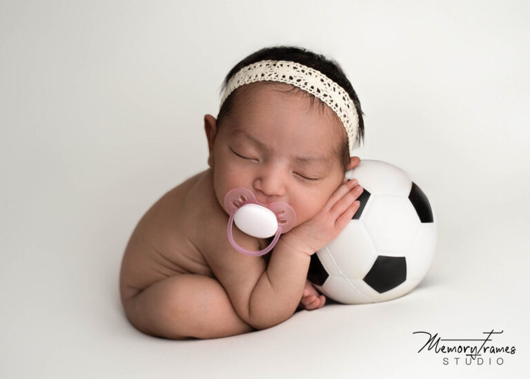 newborn baby posed on a ball for newborn phootshoot in kitchener, Toronto newborn photographer, brampton newborn photographer