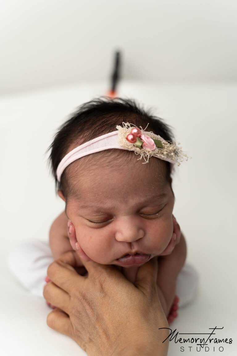 cambridge newborn photographer posing baby girl in froggy pose for newborn photoshoot