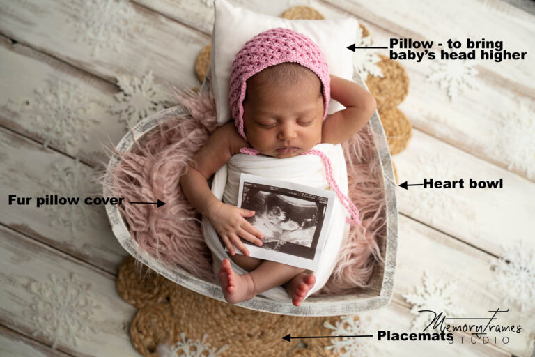 baby girl holding ultra sound photo of herself for photoshoot, kitchener newborn photographer, newborn photos at home