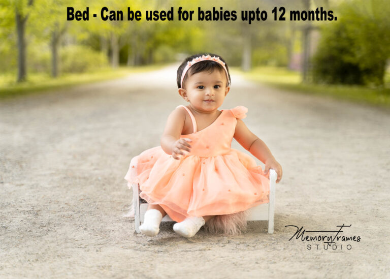 baby sitting on a wooden prop bed, how to take baby photos at home.