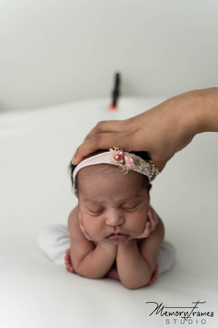 kitchener photographer supporting baby's head for froggy pose, toronto newborn photographer, newborn photos at home