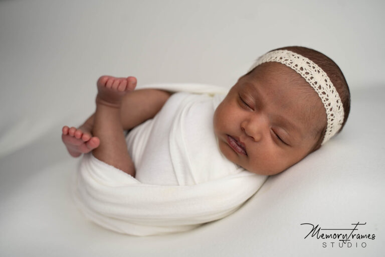 newborn baby sleeping on white backdrop in kithcener newborn photographers studio, how to take baby photos at home