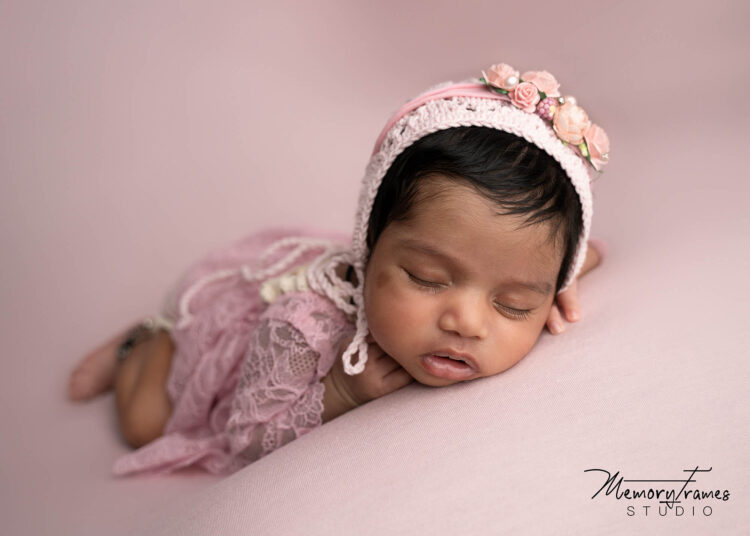 chin on hands pose for newborn photoshoot, baby posed on pink fabric, waterloo newborn photographer