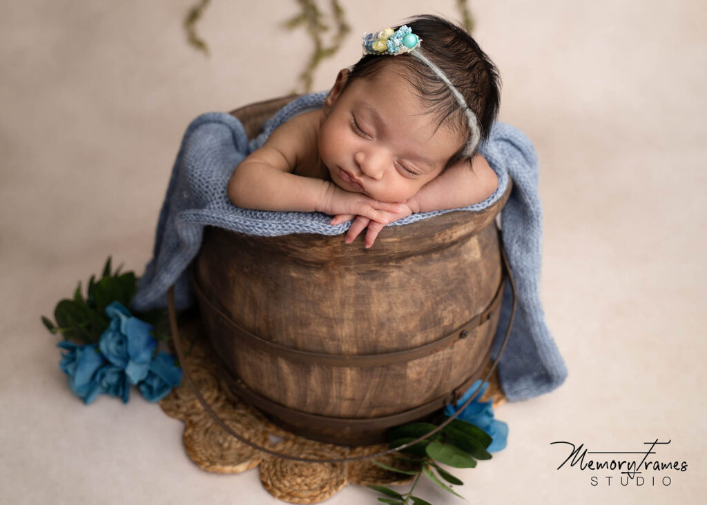 newborn baby girl posed in bucket in kitchener studio, rainbow baby photoshoot