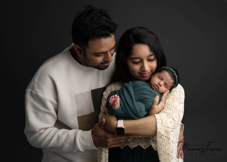 mother father and baby posed by kitchener photographer, family photoshoot in kitchener newnborn studio