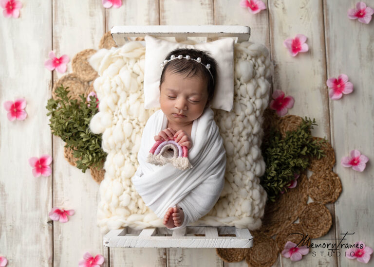 newborn baby holding rainbow in hands for photoshoot in kitchener, rainbow baby photoshoot