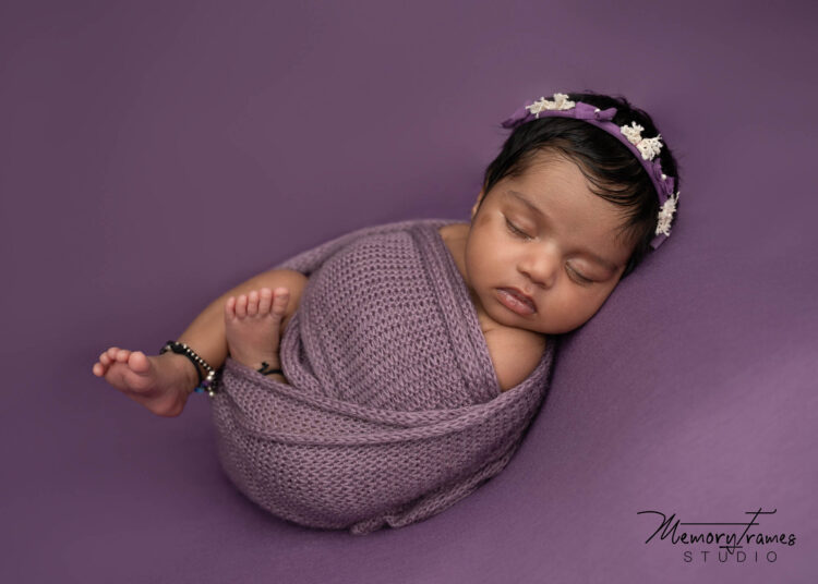 baby wrapped in purple wrap for newborn photoshoot in kitchener studio, kitchener newborn photographer