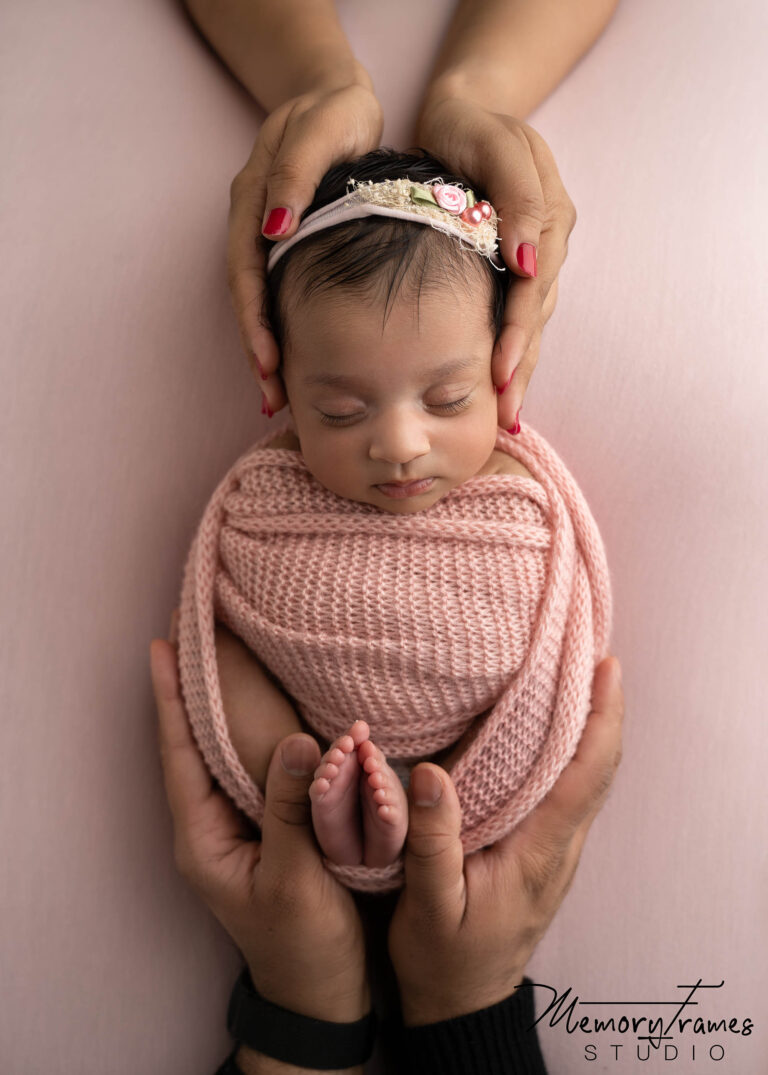 baby held by mother and father for newborn photoshoot, kitchener newborn photography