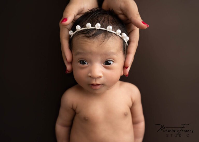 newborn baby looking at camera at kitchener studio