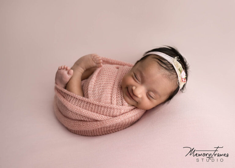 baby smiling for newborn photoshoot, newborn baby posed in kitchener for phtoshoot