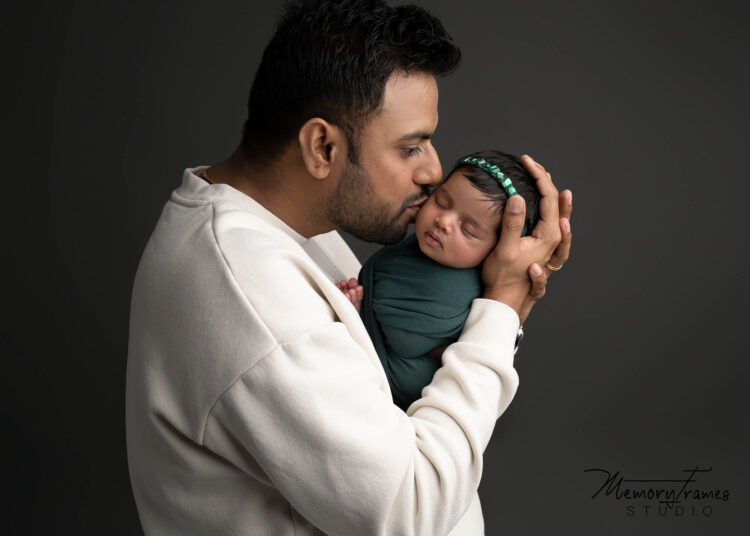 family photo taken by kitchener newborn photographer, waterloo family photographer, father daughter posed together for newborn photoshoot